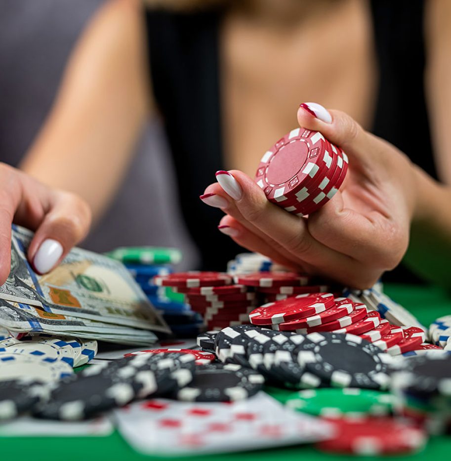female-player-counts-chips-money-raises-bet-while-playing-poker-casino