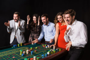 group-young-people-roulette-table-black-background-young-people-made-bets-game-wait-result-bright-emotions